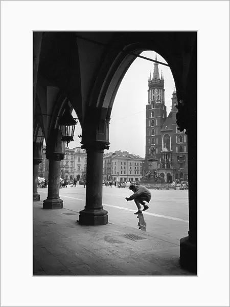 Skateboarder on the steps of The Cloth Hall, Krakow, Poland