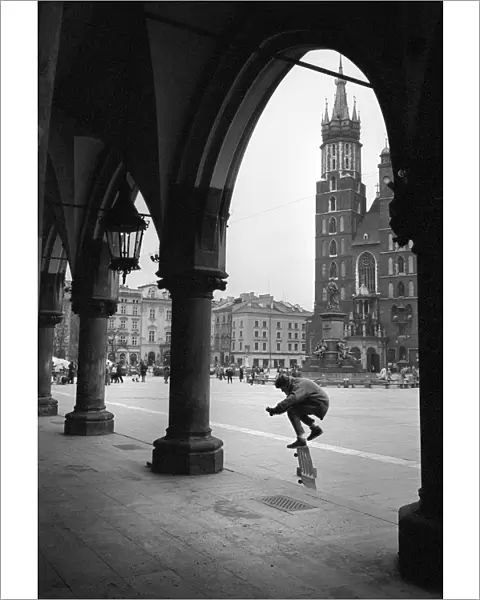 Skateboarder on the steps of The Cloth Hall, Krakow, Poland