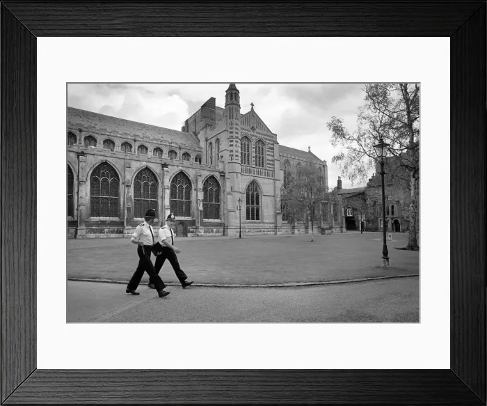 Framed Print : Two policemen march in step past Bury St Edmunds Abbey Framed Print : Two policemen march in step past Bury St Edmunds Abbey