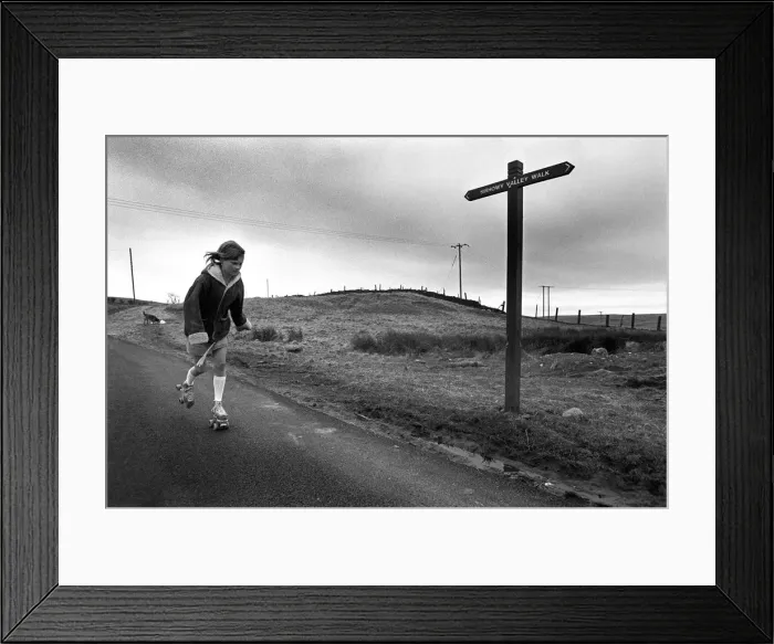 Framed Print : Young girl rollerskating past Sirhowy Valley Walk sign Framed Print : Young girl rollerskating past Sirhowy Valley Walk sign