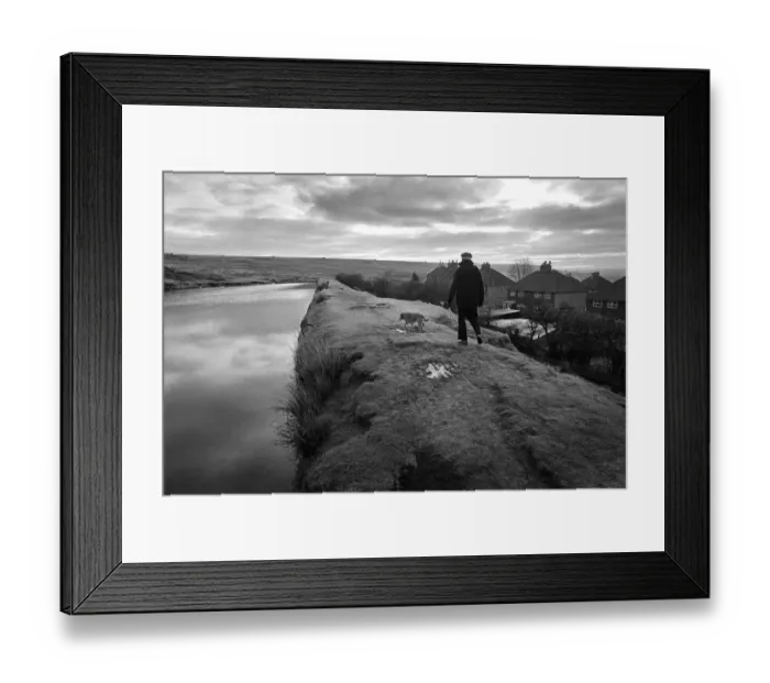 Framed Print : A man walks his dog along an embankment in Blaenavon, Wales Framed Print : A man walks his dog along an embankment in Blaenavon, Wales