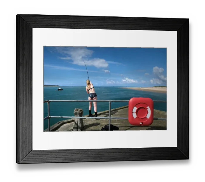 Framed Print : A young woman fishes from the pier at Aberdovey (Aberdyfi) Framed Print : A young woman fishes from the pier at Aberdovey (Aberdyfi)