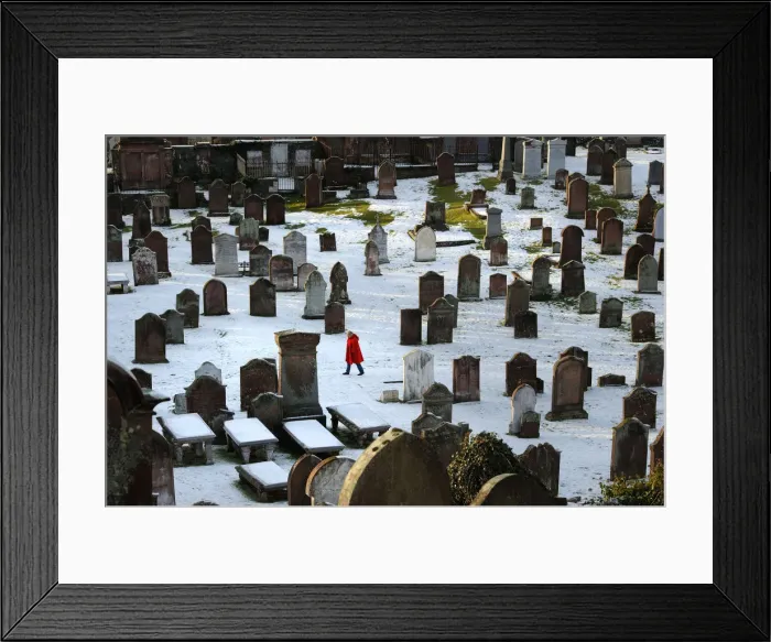 Framed Print : Woman in red coat in Kirkcudbright snowy graveyard Framed Print : Woman in red coat in Kirkcudbright snowy graveyard