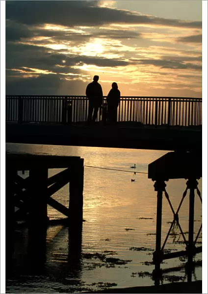 Silhouette - man and woman watching the sunset - Caernarfon