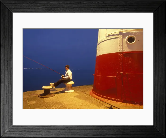 Framed Print : Teenage boy sits on a bollard while fishing, Newlyn Harbour Framed Print : Teenage boy sits on a bollard while fishing, Newlyn Harbour