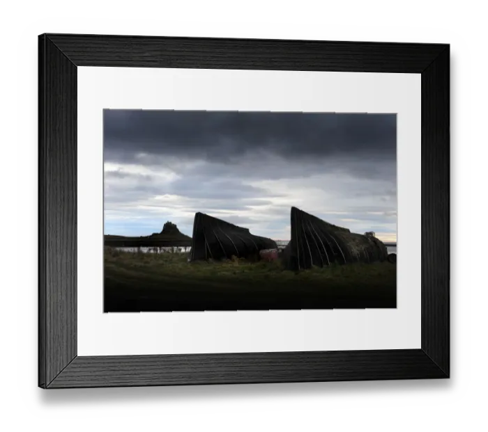 Framed Print : Black tarred upturned boats used as sheds on Holy Island Framed Print : Black tarred upturned boats used as sheds on Holy Island