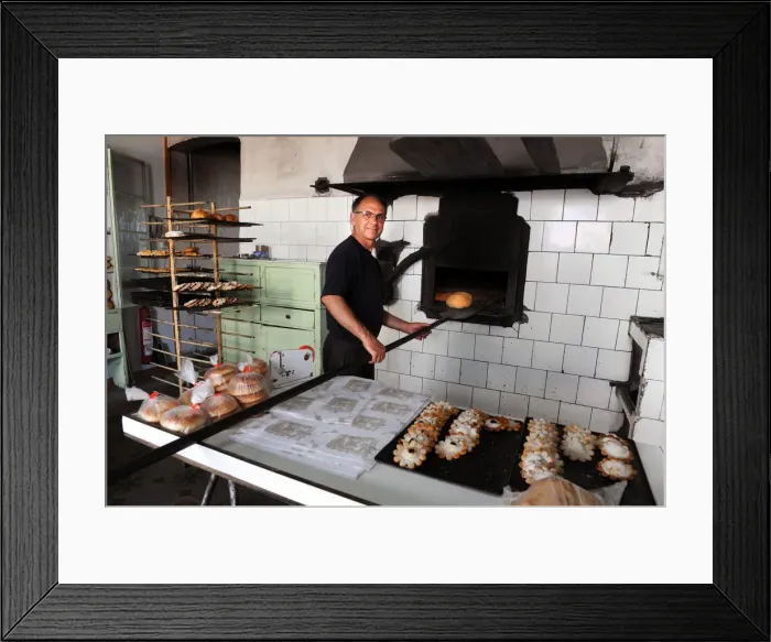 Framed Print : Baker Juan Olives bakes bread in olive wood burning oven Framed Print : Baker Juan Olives bakes bread in olive wood burning oven