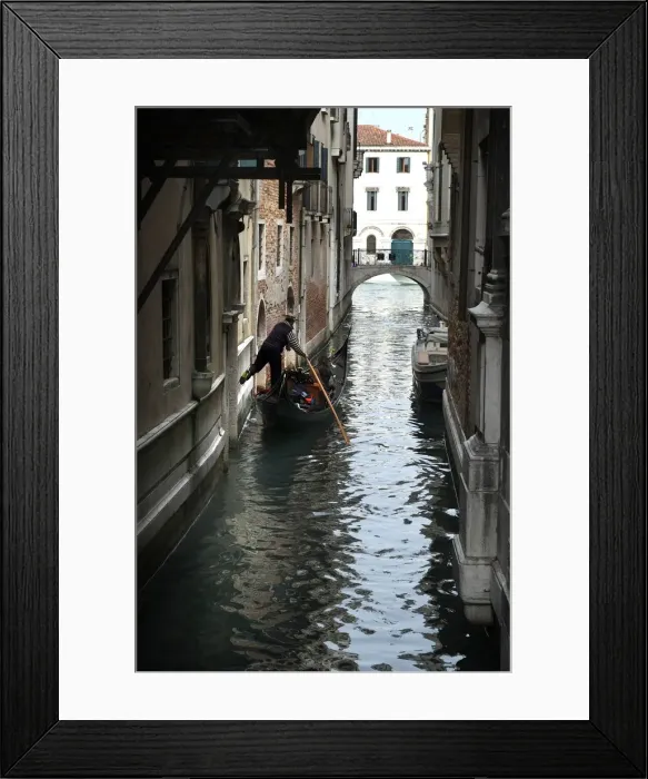 Framed Print : Gondolier fends off boat from a wall with his foot, Venice Framed Print : Gondolier fends off boat from a wall with his foot, Venice