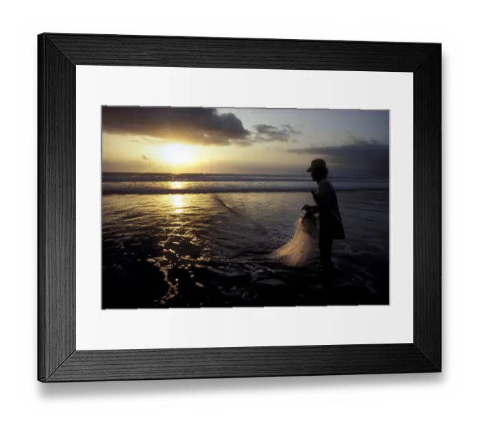Framed Print : A Balinese fisherman pauses to look at the sunset Framed Print : A Balinese fisherman pauses to look at the sunset