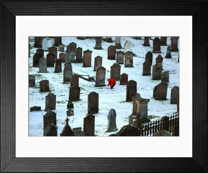 Framed Print : Lady in red coat lays bouquet on a grave, Kirkcudbright Framed Print : Lady in red coat lays bouquet on a grave, Kirkcudbright