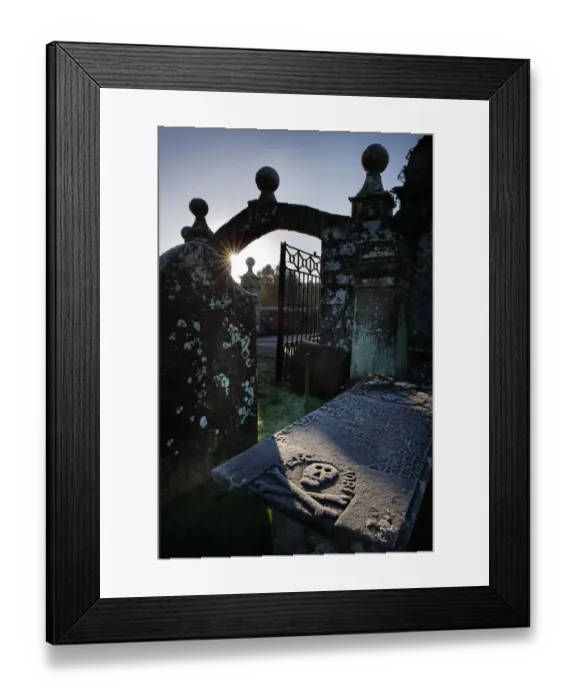 Framed Print : Winter sun highlights a skull & crossbones on a tomb Framed Print : Winter sun highlights a skull & crossbones on a tomb
