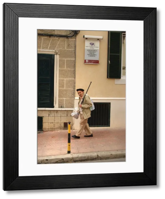 Framed Print : An old man walks down a street in Menorca, Spain Framed Print : An old man walks down a street in Menorca, Spain