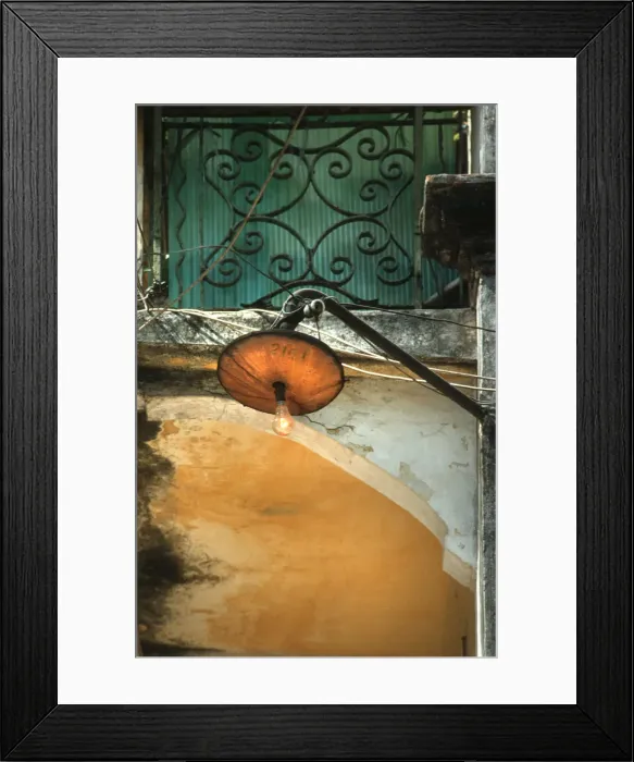 Framed Print : Light bulb glows during the day from a rickety street lamp Framed Print : Light bulb glows during the day from a rickety street lamp