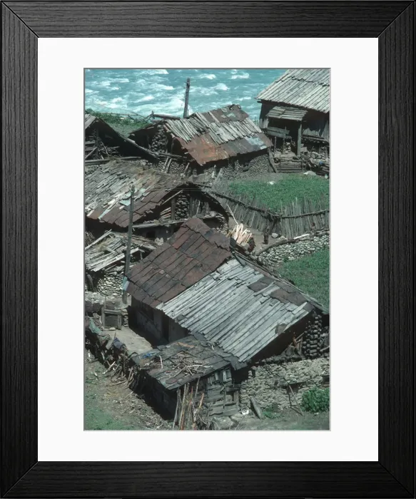 Framed Print : Ramshackle wooden houses alongside the river in Sind Valley Framed Print : Ramshackle wooden houses alongside the river in Sind Valley