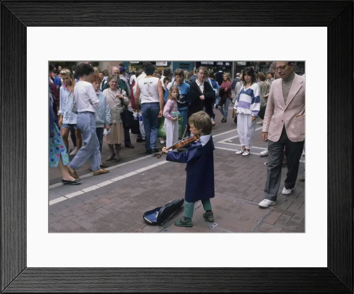 Framed Print : Small boy busking with his violin for an audience in Dublin Framed Print : Small boy busking with his violin for an audience in Dublin