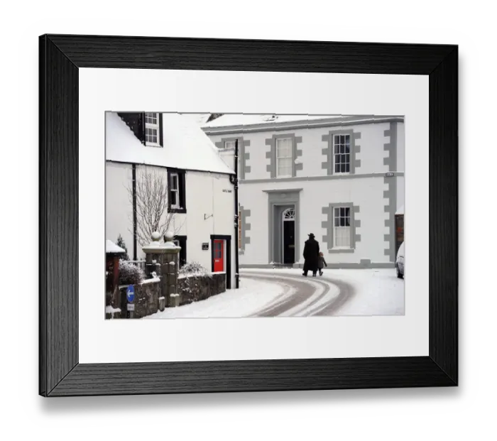 Framed Print : Man in a heavy overcoat walks a small child through the snow Framed Print : Man in a heavy overcoat walks a small child through the snow
