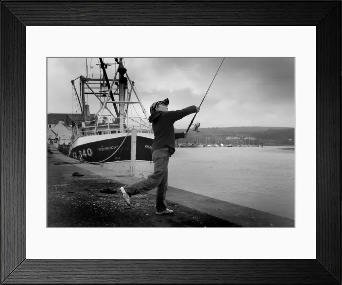 Framed Print : Boy casts his fishing line into River Dee at Kirkcudbright Framed Print : Boy casts his fishing line into River Dee at Kirkcudbright