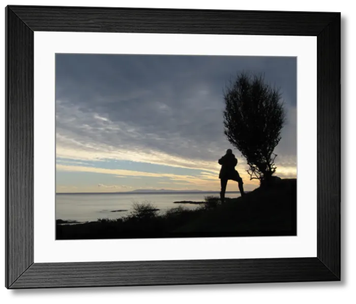 Framed Print : A man takes a photograph of the Isle of Man from Knockbrex