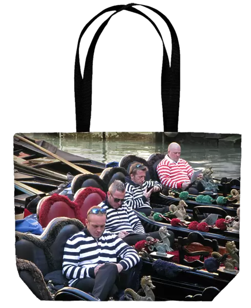 Four gondoliers in their gondolas behind St Marks, Venice