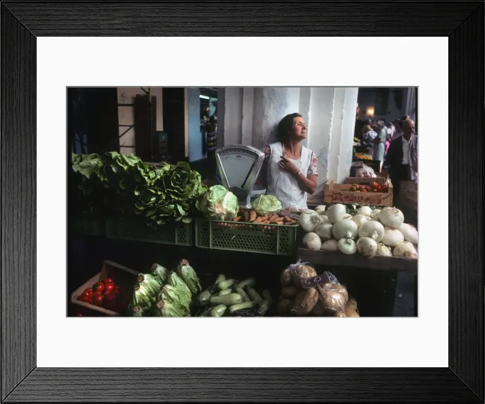 Framed Print : A woman stallholder behind her vegetable stall, Menorca Framed Print : A woman stallholder behind her vegetable stall, Menorca