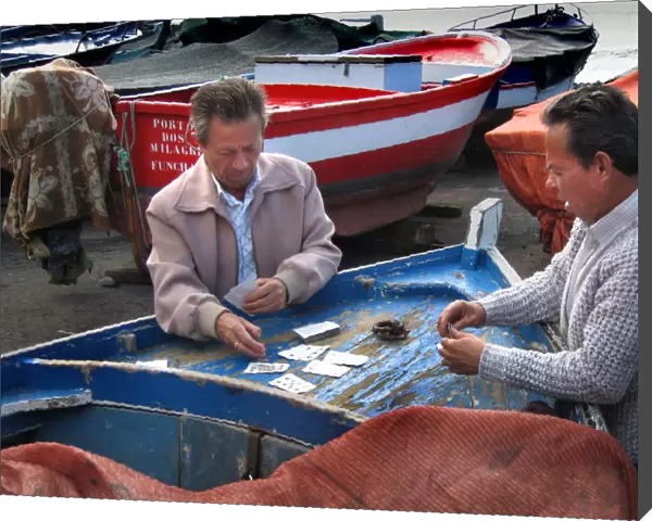 Fishermen play cards on a fishing boat at Funchal