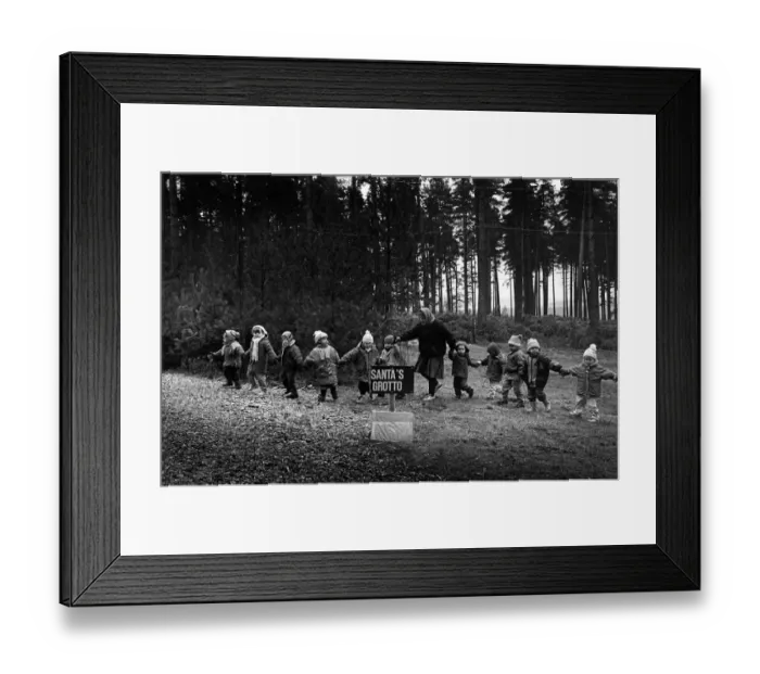 Framed Print : A line of small children are led to Santas grotto Framed Print : A line of small children are led to Santas grotto