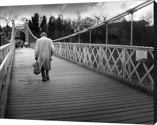 Old man crosses Queens Park suspension footbridge, Chester