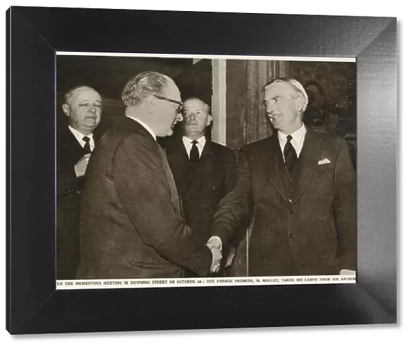 Sir Anthony Eden (right) shakes hands with French Premier Guy Alcide Mollet (1905-1975