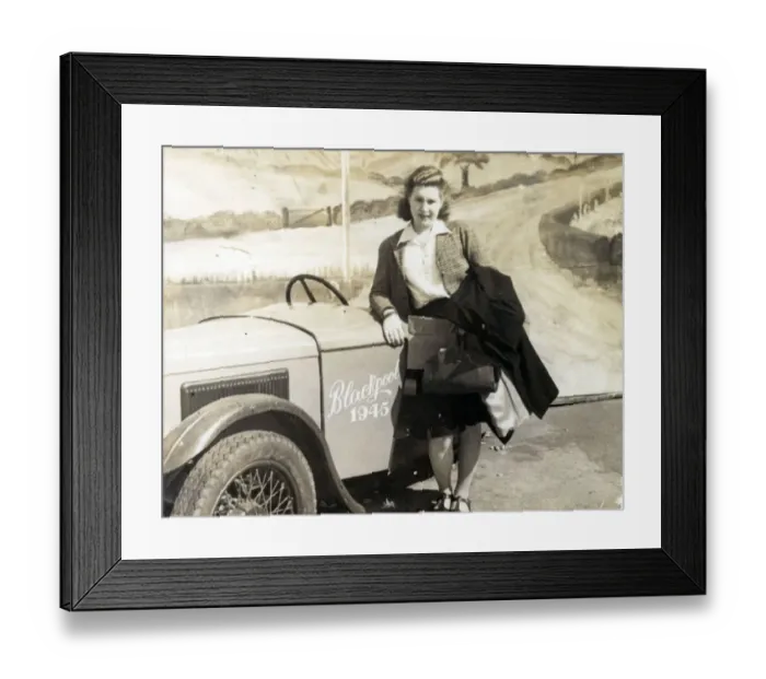Framed Print : Young lady on the Blackpool seafront poses for a Sunny Snaps photograph alongside a Framed Print : Young lady on the Blackpool seafront poses for a Sunny Snaps photograph alongside a