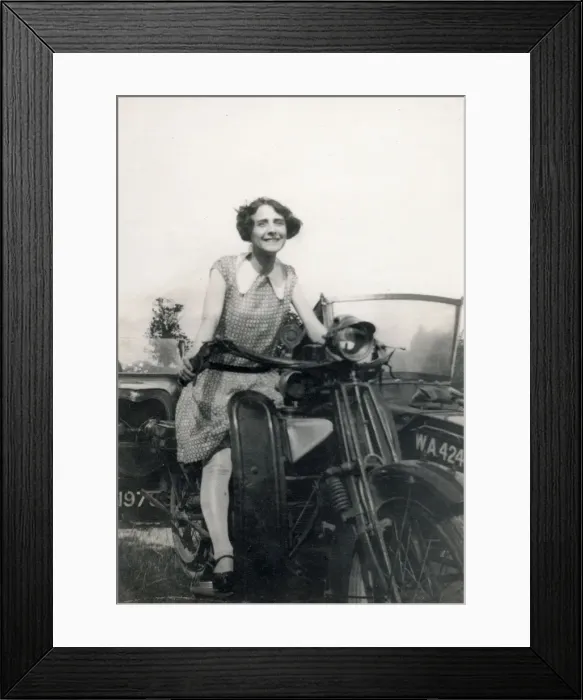 Framed Print : Young lady seated on a Motorbike (with sidecar) Date: circa 1930s Framed Print : Young lady seated on a Motorbike (with sidecar) Date: circa 1930s