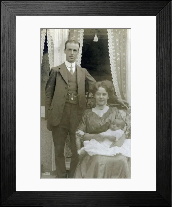 Framed Print : A young middle class couple pose for a photograph with their new little baby Framed Print : A young middle class couple pose for a photograph with their new little baby