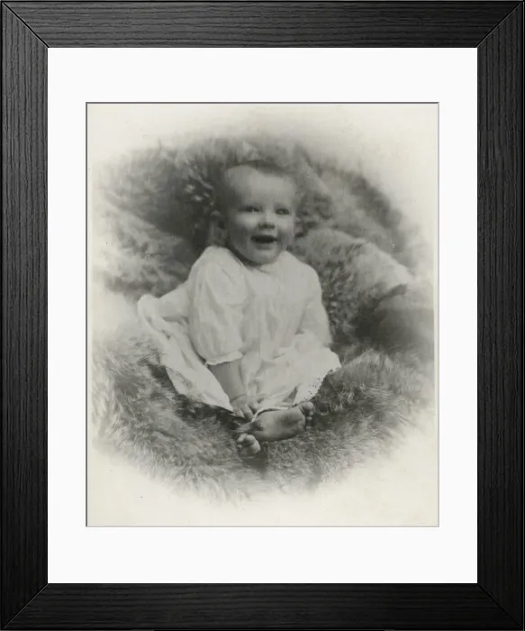 Framed Print : A young baby on a fur-covered seat Framed Print : A young baby on a fur-covered seat