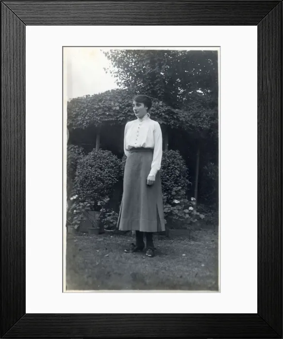 Framed Print : A female student (?) posing for a photograph in a suburban garden. circa 1910s Framed Print : A female student (?) posing for a photograph in a suburban garden. circa 1910s