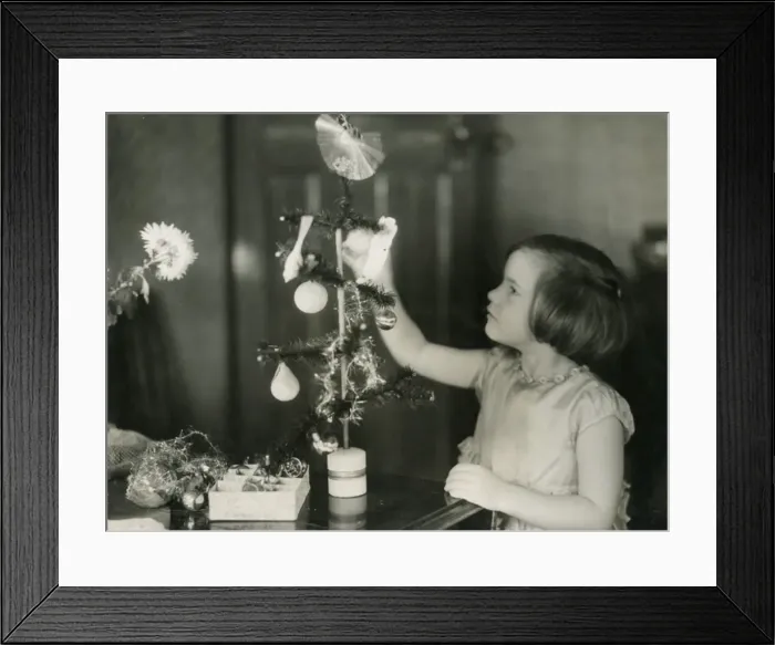 Framed Print : GIRL DECORATES TREE Framed Print : GIRL DECORATES TREE