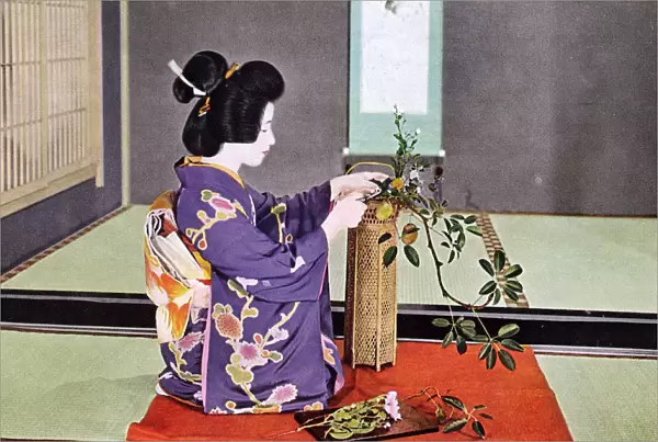 JAPANESE FLOWER ART. A Japanese woman practising Ikebana
