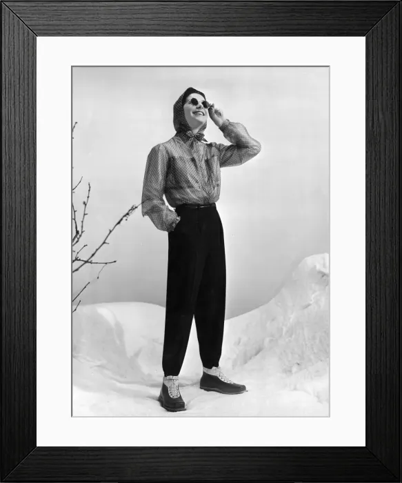 Framed Print : SKI-WEAR. Womens skiing suit composed of dark woollen trousers worn with Framed Print : SKI-WEAR. Womens skiing suit composed of dark woollen trousers worn with