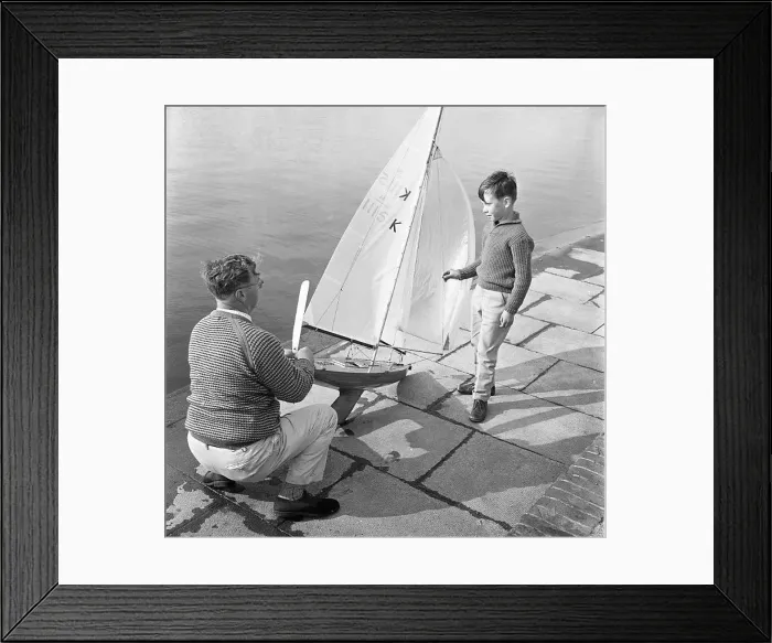 : Man and boy with model sailing boat : Man and boy with model sailing boat