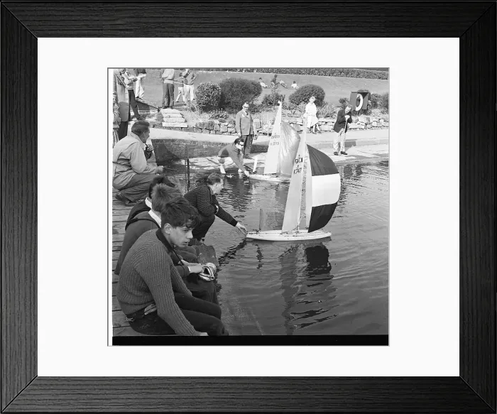 : People with model sailing boats on a pond : People with model sailing boats on a pond