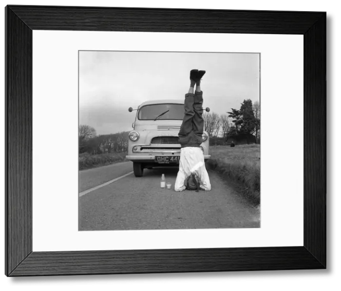 : Man standing on his head in the road : Man standing on his head in the road