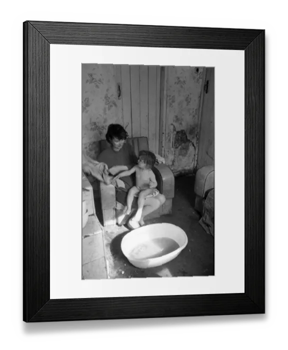 Framed Print : Woman bathing baby, Falls Road, Northern Ireland Framed Print : Woman bathing baby, Falls Road, Northern Ireland