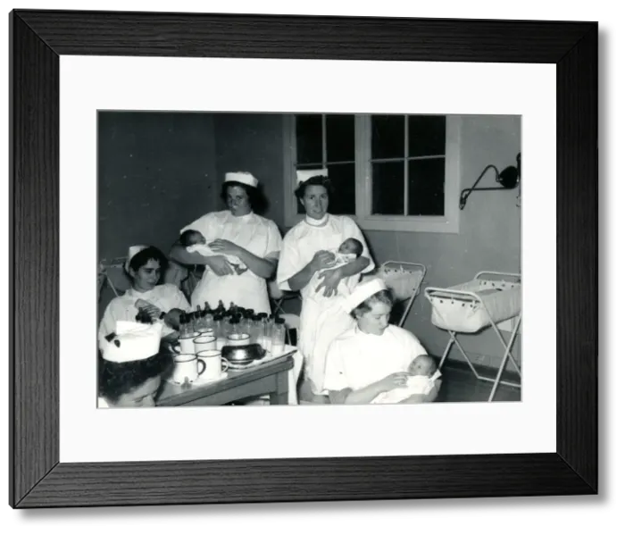 Framed Print : Nurses with babies in hospital nursery