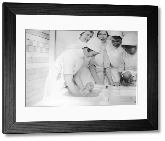 Framed Print : Nurses bathing newborn babies Framed Print : Nurses bathing newborn babies