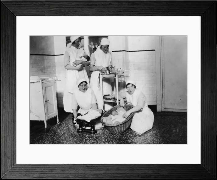Framed Print : Nurses weighing babies Framed Print : Nurses weighing babies