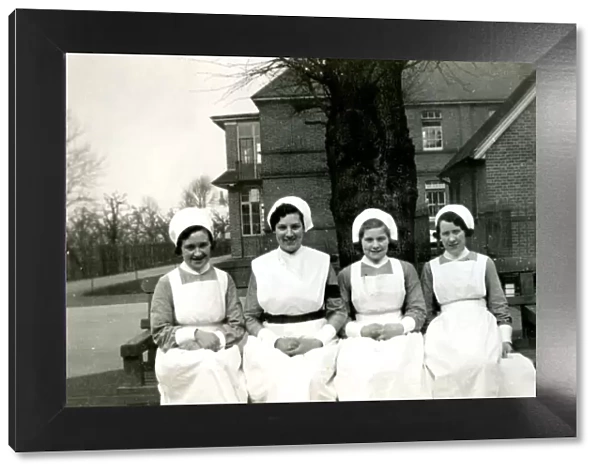 Nurses on bench outside hospital