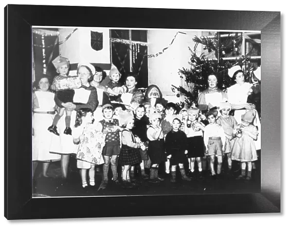 Nurses, Father Christmas and children at Christmas party