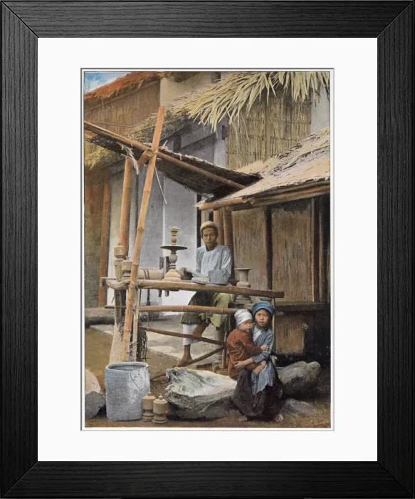 Framed Print : Vietnamese wood worker and his family outside their home. Date: 1890s Framed Print : Vietnamese wood worker and his family outside their home. Date: 1890s
