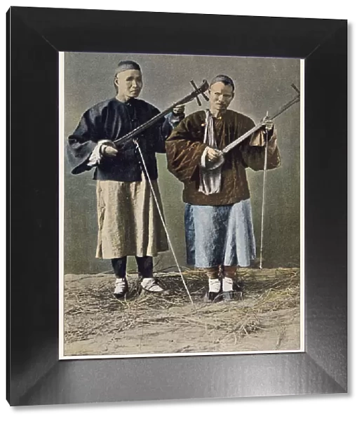 Two blind beggars playing stringed instruments. Date: 1890s