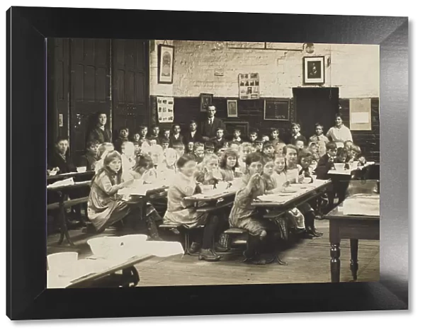 Schoolchildren ear their midday meal at their desks. Date: early 20th century