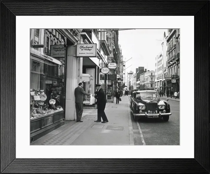 Framed Print : A gentleman hands over his heavy bag of expensive French chocolates to his chauffeur Framed Print : A gentleman hands over his heavy bag of expensive French chocolates to his chauffeur