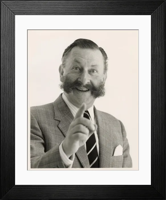 Framed Print : Head and shoulders portrait of a smartly dressed man with a bushy moustache pointing Framed Print : Head and shoulders portrait of a smartly dressed man with a bushy moustache pointing